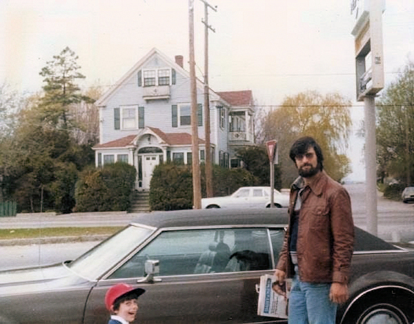 An early family photograph with a classic car